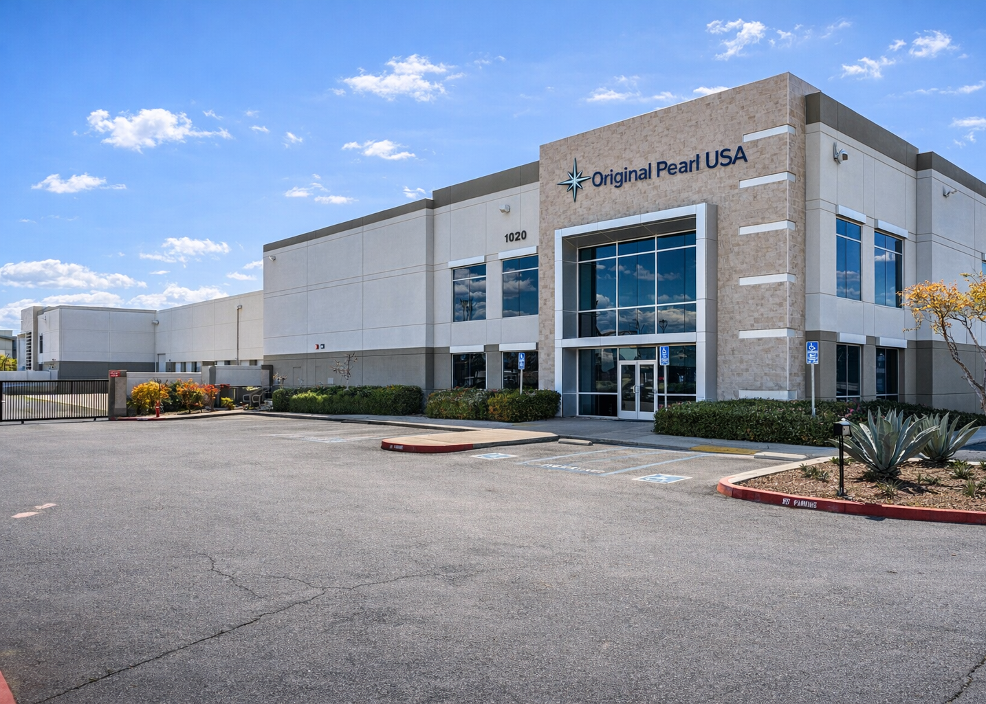Commercial building with 'Original Pearl USA' signage on a clear day
